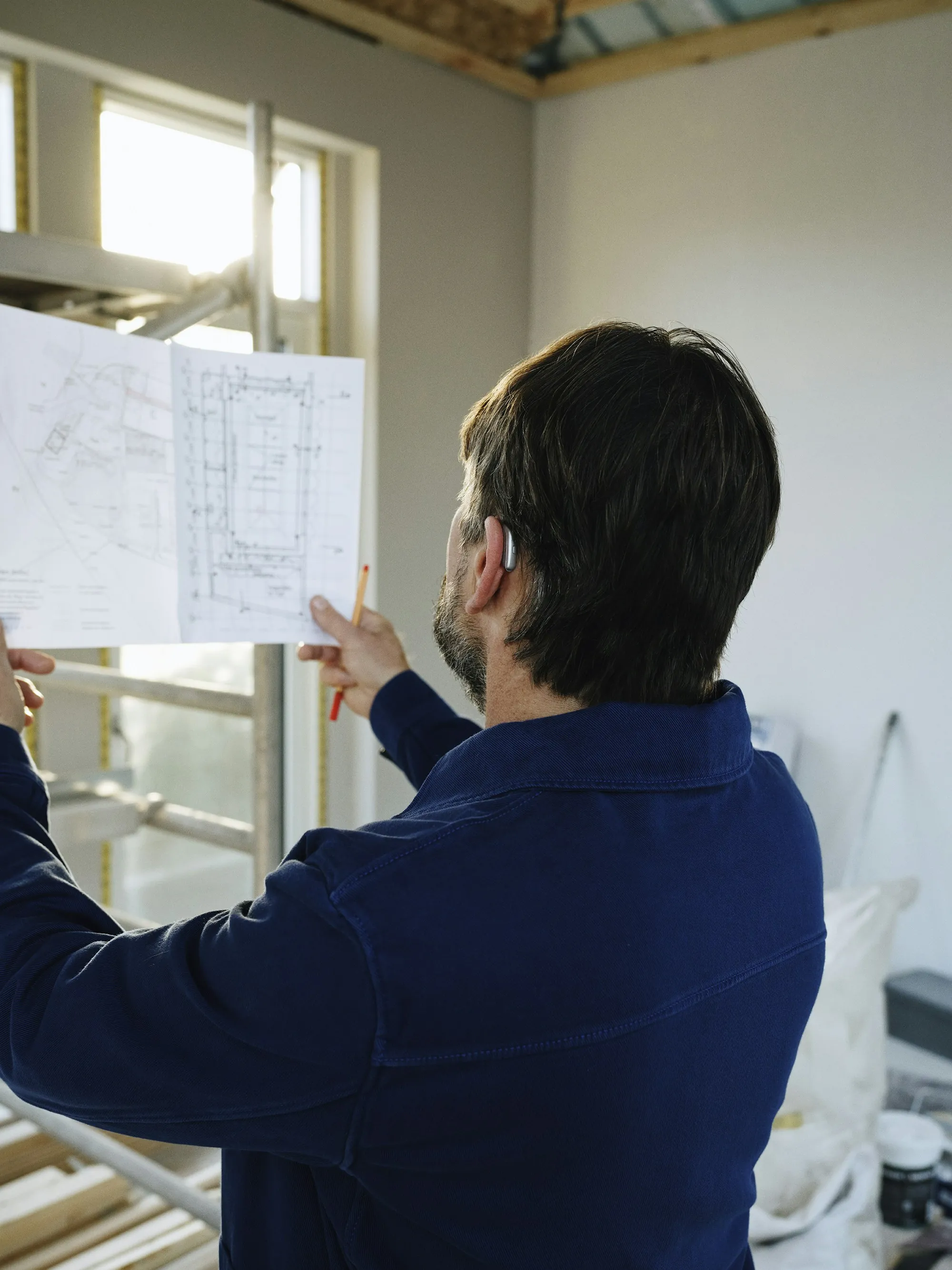 Man reviewing a building plan