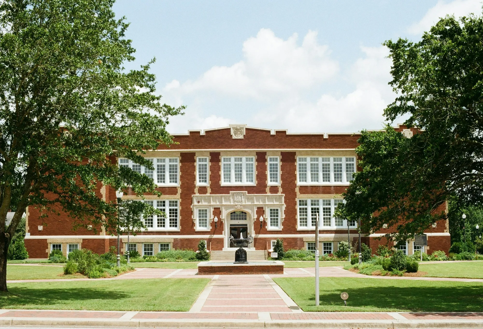Older brick school building and lawn